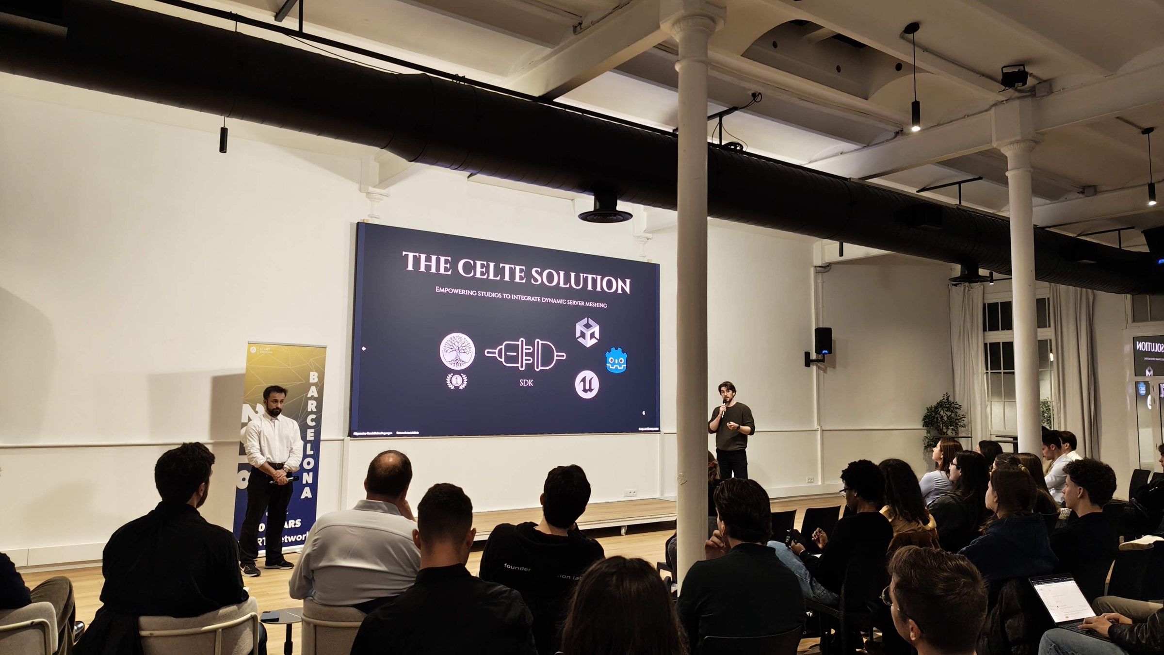 A team pitching on stage to a full room, 'The Celte solution' on the screen