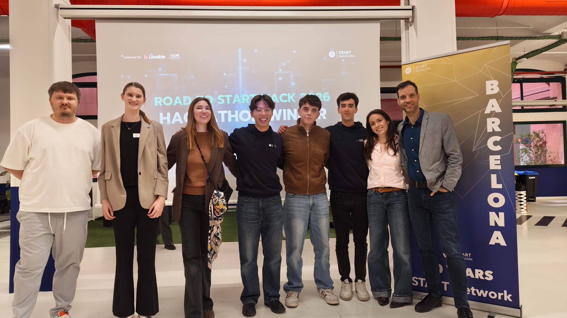 The Road to START Hack 2026 winners with the jury in front of the hackathon screen and a START Barcelona banner