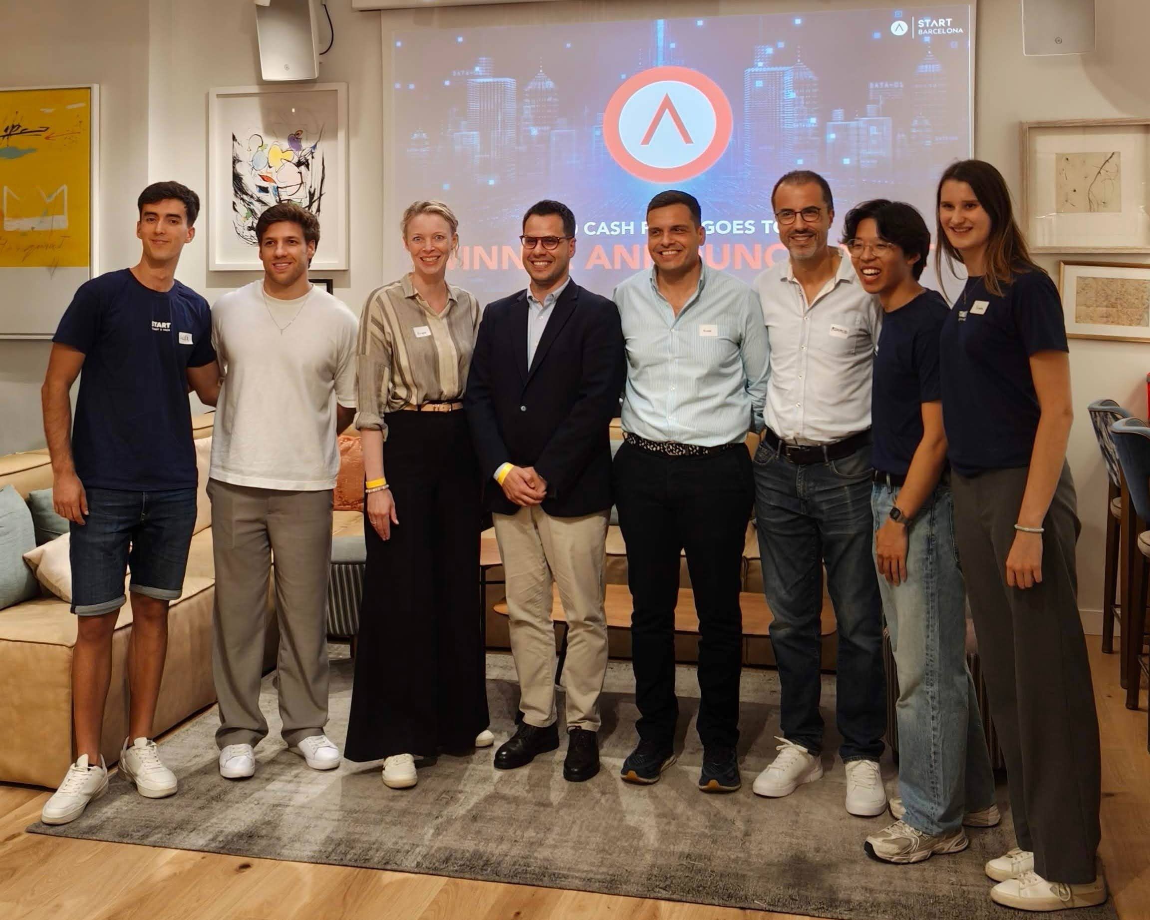 Speakers, partners and organisers lined up in front of the START Barcelona screen after LaunchLab